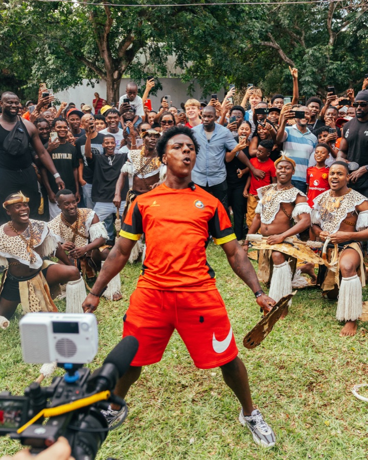 A child holding a soccer ball at a community gathering